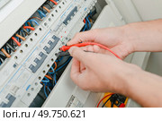 male worker checking all the fuses. Стоковое фото, агентство Ingram Publishing / Фотобанк Лори