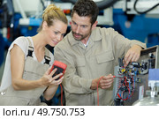 workers checking mutimeters result. Стоковое фото, агентство Ingram Publishing / Фотобанк Лори