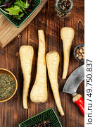 Uncooked parsnips roots on the kitchen table. Fresh vegetable. Top view.. Close up parsnip. Стоковое фото, агентство Ingram Publishing / Фотобанк Лори