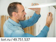 a carpenter screwing a furniture. Стоковое фото, агентство Ingram Publishing / Фотобанк Лори