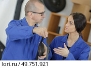 teacher holding smooth rubber belt. Стоковое фото, агентство Ingram Publishing / Фотобанк Лори