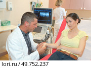 male doctor analyzing patient arm with tendon sonography. Стоковое фото, агентство Ingram Publishing / Фотобанк Лори