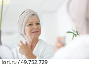 mature well groomed woman with bottle of perfumes. Стоковое фото, агентство Ingram Publishing / Фотобанк Лори