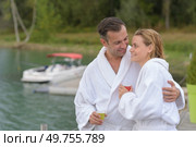 senior couple in bathrobe standing on a pontoon. Стоковое фото, агентство Ingram Publishing / Фотобанк Лори