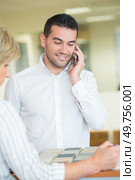young businessman talking on the phone at the office. Стоковое фото, агентство Ingram Publishing / Фотобанк Лори