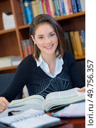 woman with books in the library. Стоковое фото, агентство Ingram Publishing / Фотобанк Лори