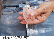 Hands holding menstrual cup over violet background, eco friendly and zero waste solution. Menstrual cap over violet background. Стоковое фото, агентство Ingram Publishing / Фотобанк Лори