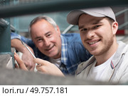 builder aprentice smiling with his teacher. Стоковое фото, агентство Ingram Publishing / Фотобанк Лори