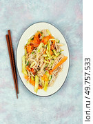 Salad with enoki mushrooms or needle mushroom, carrots, cucumber, fried sesame seeds. Enokitake salad. Flat lay.. Enoki mushroom salad. Стоковое фото, агентство Ingram Publishing / Фотобанк Лори