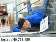 businessman has fallen down the stairs in the workplace. Стоковое фото, агентство Ingram Publishing / Фотобанк Лори