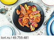 Baked meat steaks marinated in autumn fruits. BBQ pork. Top view.. A plate of roasted pork. Стоковое фото, агентство Ingram Publishing / Фотобанк Лори