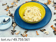 Yellow millet grain porridge with mushrooms. Vegan healthy food.. Tasty millet porridge with roasted mushrooms. Стоковое фото, агентство Ingram Publishing / Фотобанк Лори