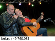 female guitarist and singer performing on stage. Стоковое фото, агентство Ingram Publishing / Фотобанк Лори
