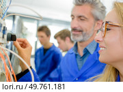 a female apprentice is an electrician. Стоковое фото, агентство Ingram Publishing / Фотобанк Лори