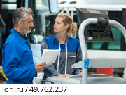 cheerful superviser and female worker at repair shop. Стоковое фото, агентство Ingram Publishing / Фотобанк Лори