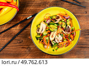 Salad of squid tentacles or calamari and vegetables in a bowl on rustic wooden table.. Spicy squid salad with mix vegetables. Стоковое фото, агентство Ingram Publishing / Фотобанк Лори