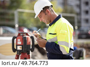mature geometer working on construction site. Стоковое фото, агентство Ingram Publishing / Фотобанк Лори