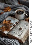 An open book with a cup of coffee placed on top of it.. Open Book With Cup of Coffee. Стоковое фото, агентство Ingram Publishing / Фотобанк Лори
