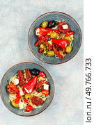 A delicious salad of pickled soybean sprouts, dried tomatoes, olives and peppers. Chinese food. Top view.. Vegan Salad of Pickled Vegetables and Soybeans. Стоковое фото, агентство Ingram Publishing / Фотобанк Лори