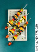 Vegetable vegetarian kebabs, tomatoes, cabbage, pepper grilled on skewers. Vegan food concept. Top view.. Grilled vegetables on skewers. Стоковое фото, агентство Ingram Publishing / Фотобанк Лори
