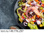A plate of octopus salad with herbs, potatoes and olives.. Grilled octopus with salad on a plate. Стоковое фото, агентство Ingram Publishing / Фотобанк Лори