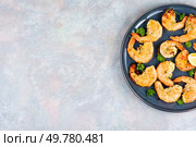 Grilled giant Argentinian red prawns with herb marinade. Plate with seafood. Free space for your text.. Prawns, grilled river shrimp. Стоковое фото, агентство Ingram Publishing / Фотобанк Лори