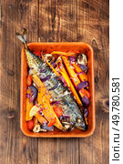 Grilled mackerel fish with sweet potato, herbs and spices. Georgian cuisine. Rustic style.. Cooked mackerel fish. Стоковое фото, агентство Ingram Publishing / Фотобанк Лори