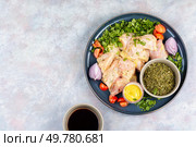 Raw and fresh chicken breast marinated in cilantro herb. Ready for baking.. Fresh herb marinated chicken meat. Стоковое фото, агентство Ingram Publishing / Фотобанк Лори