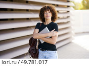 A fashionable and confident young woman, with stunning curly hair is seen warmly embracing her sleek laptop in a vibrant and stimulating outdoor environment that encourages both creativity and success. A Confident Businesswoman Working on Her Laptop in a Modern Urban Cityscape Setting. Стоковое фото, агентство Ingram Publishing / Фотобанк Лори