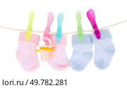 blue and pink baby clothes hanging on rope isolated on white. baby socks. Стоковое фото, агентство Ingram Publishing / Фотобанк Лори