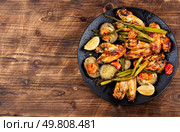Barbecue grilled chicken wings with fried green asparagus. Traditional baked BBQ. Appetizing fried meat. Copy space.. Spicy grilled chicken wings. Стоковое фото, агентство Ingram Publishing / Фотобанк Лори