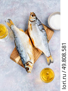 Glass of beer and snacks with dried fish.. Beer and dried fish. Стоковое фото, агентство Ingram Publishing / Фотобанк Лори