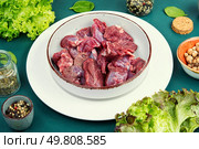Sliced raw venison deer meat for a stew.. Plate of raw goulash. Стоковое фото, агентство Ingram Publishing / Фотобанк Лори