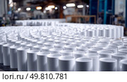 A factory producing identical plastic products endlessly. Symbol of a major environmental problem caused by urban overconsumption waste. Abstract image. Стоковое AI-изображение, AI-художник ALLA YURTAYEVA / Фотобанк Лори