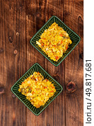 Bowls with colorful spices on wooden rustic background. Aromatic spices with raisins, nuts. Eastern spices and herbs in bowl. Стоковое фото, агентство Ingram Publishing / Фотобанк Лори