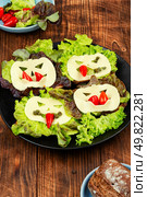 Stylish sandwiches for Halloween on wooden rustic background.. Halloween party food. Стоковое фото, агентство Ingram Publishing / Фотобанк Лори
