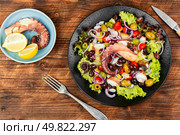 Plate of octopus tentacles, olives and potatoes.. Fresh octopus salad. Стоковое фото, агентство Ingram Publishing / Фотобанк Лори