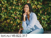 A thoughtful and contemplative young woman poses gracefully amid vibrant, lush ivy, reflecting a sense of tranquility and a deep connection with the beauty of nature surrounding her. A contemplative woman sits peacefully in nature, surrounded by a beautiful ivycovered backdrop. Стоковое фото, агентство Ingram Publishing / Фотобанк Лори