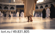 Barefoot pilgrim walking toward Kaaba during Hajj in Mecca captures devotion, spirituality, tradition and sacred Islamic journey in holy mosque at sunrise. Стоковое AI-изображение, AI-художник Катерина Бондарец / Фотобанк Лори