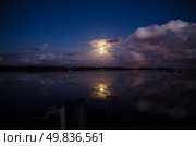 Moon rising and reflecting in the still water of a lake. Стоковое фото, агентство Ingram Publishing / Фотобанк Лори