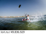 Kiteboarder enjoy surfing on a sunny day. Стоковое фото, агентство Ingram Publishing / Фотобанк Лори