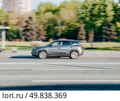 Car JAC JS4 driving fast on city street with blurred background. Moskvitch 3 crossover in motion on wide motorway. Редакционное фото, фотограф Константин Григорьев / Фотобанк Лори