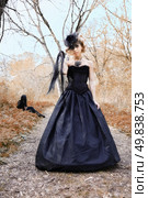 aggrassive woman in old style black dress. outdoor shot. Стоковое фото, агентство Ingram Publishing / Фотобанк Лори
