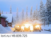 Snowmobile parking on snow in Kiruna Sweden. Стоковое фото, агентство Ingram Publishing / Фотобанк Лори
