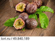 Passion fruits on wooden background. Стоковое фото, агентство Ingram Publishing / Фотобанк Лори