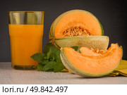 Honeydew melon juice on a wooden table background. Стоковое фото, агентство Ingram Publishing / Фотобанк Лори