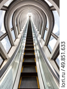 perspective escalators stairway inside contemporary blue glass business centre, concept of successful career elevation. Стоковое фото, агентство Ingram Publishing / Фотобанк Лори