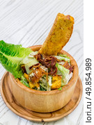 Fresh Ceasar Salad with crispy bacon in wooden bowl. Стоковое фото, агентство Ingram Publishing / Фотобанк Лори