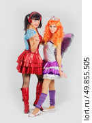 Two attractive girls in anime costumes with wings. Стоковое фото, агентство Ingram Publishing / Фотобанк Лори