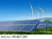 solar panels and wind turbines under blue sky on summer landscape. solar panels and wind turbines under blue sky. Стоковое фото, агентство Ingram Publishing / Фотобанк Лори